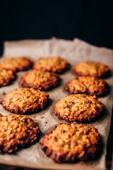 Homemade Oatmeal Cookies with Raisins on Parchment Paper. Vertical Orientatio and Copy Space.