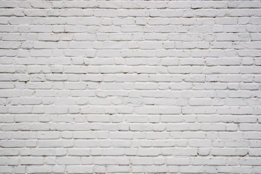 Background or backdrop of white chipped brick wall.