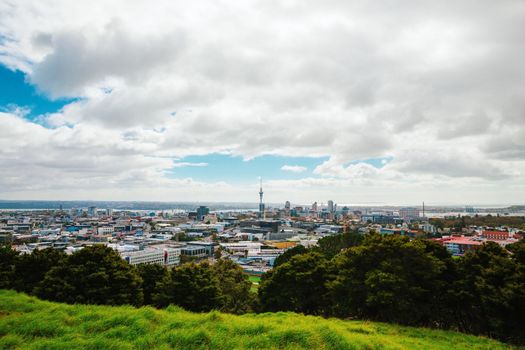 Auckland view from Mt Eden with a person walking along the path towards the city, New Zealand