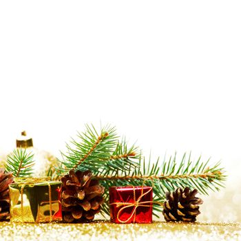 Christmas card with fir tree branch and decoration on golden glitter background