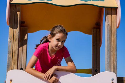 Little girl playing in a playground on the beach