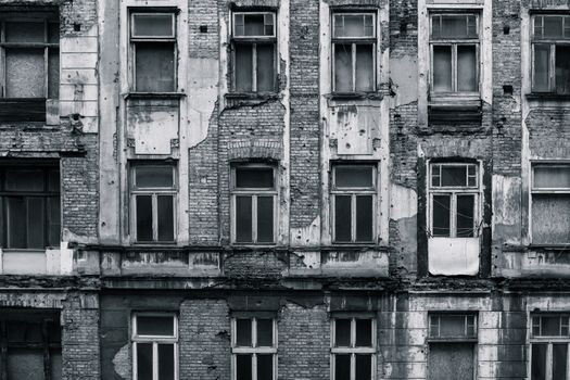 A front of the building in the center of Warsaw that is partially destroyed by nature and climate. Grunge look makes it feel depressed. Black and white colors to make it more contrast looking on electronic devices