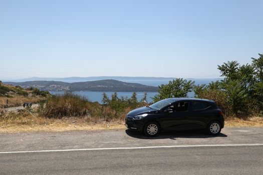 A car parked on the bending automobile road in the hills of Croatia