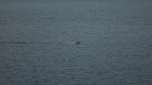 Lonely boat far away from me. Wide screen image