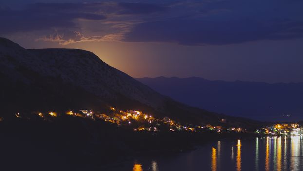 Close to midnight when the Moon has almost shown from the mountains. Bright blue tone