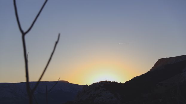 Warm and matte sunset on a rocky hill