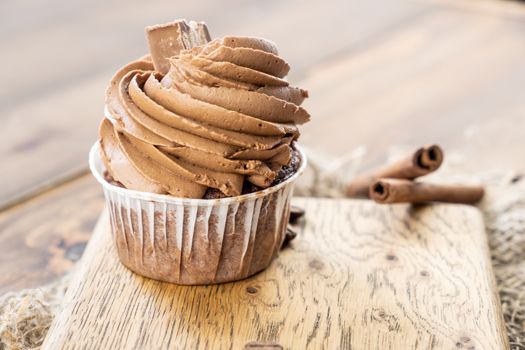 brown cupcakes with cocoa cream, cinnamon and coffee