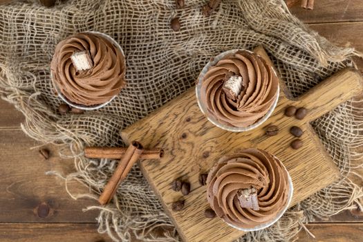 brown cupcakes with cocoa cream, cinnamon and coffee