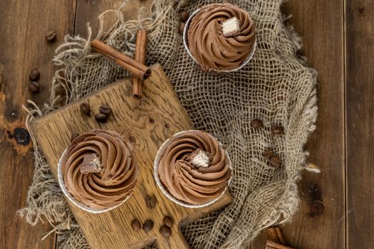 brown cupcakes with cocoa cream, cinnamon and coffee