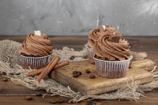 brown cupcakes with cocoa cream, cinnamon and coffee