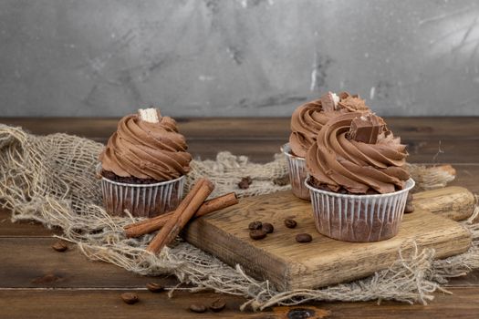 brown cupcakes with cocoa cream, cinnamon and coffee