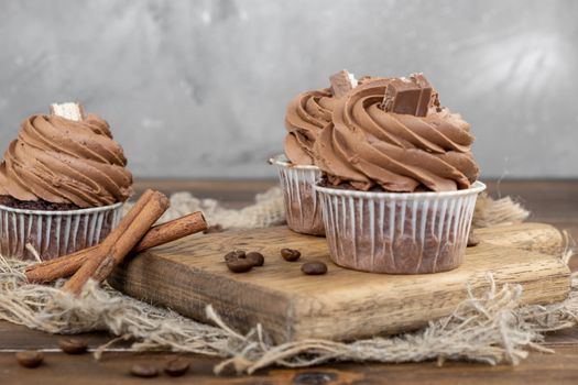 brown cupcakes with cocoa cream, cinnamon and coffee