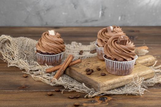 brown cupcakes with cocoa cream, cinnamon and coffee