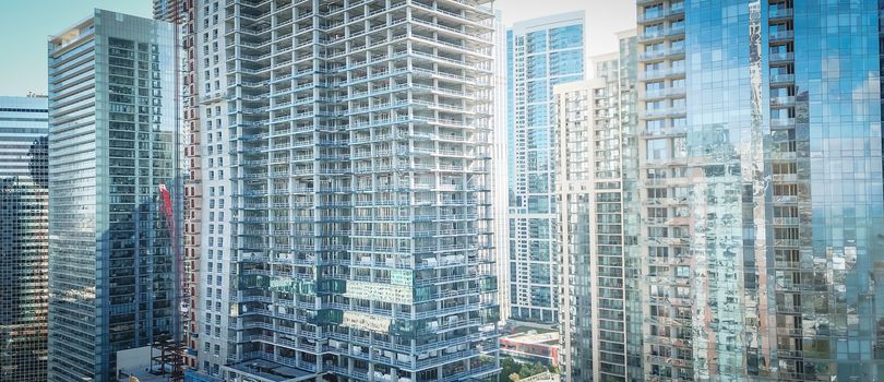 Panorama drone close-up view of Chicago skyline offices and commercial buildings along riverside