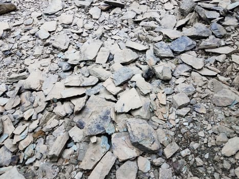 broken or chipped grey rocks or stones on the ground