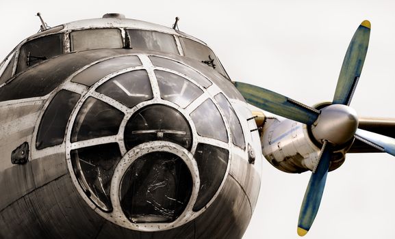 Old plane isolated. The nose of the aircraft, cockpit and aircraft engine. Old plane close up on a white background.