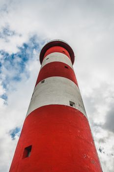 Lighthouse of Port-La-Nouvelle in red and white on cloudy sky in Occitanie, France