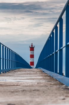 Lighthouse of Port-La-Nouvelle in red and white on cloudy sky in Occitanie, France