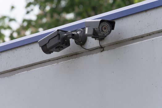 Two CCTV surveillance cameras. Concept security in the office building.