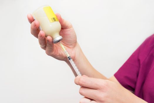 Doctor hands holding vaccine and syringe