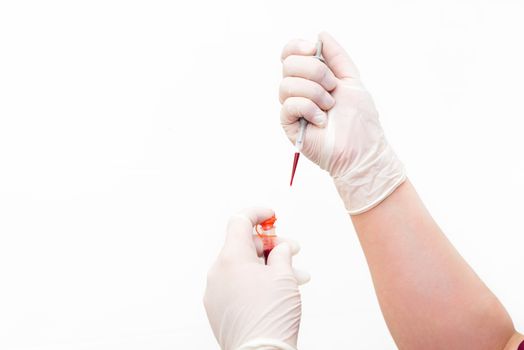 Doctor hand's holding test tube with blood in laboratory on white isolated