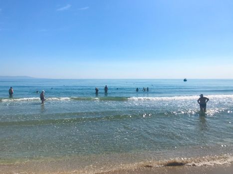 Pomorie, Bulgaria - June 05, 2019: People Relaxing On The Beach.
