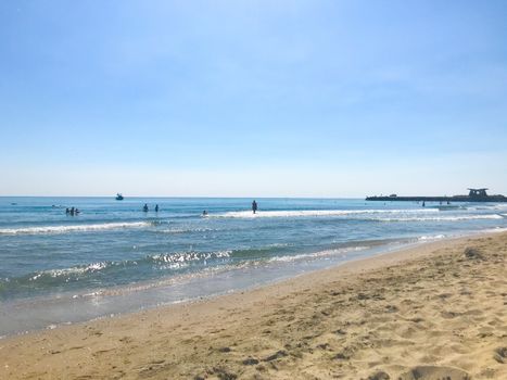 Pomorie, Bulgaria - June 05, 2019: People Relaxing On The Beach.