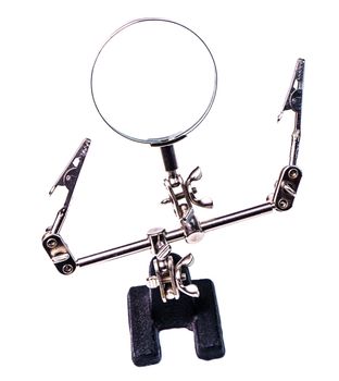The third hand device with clamps and magnifier for holding small parts during soldering isolated on white background.