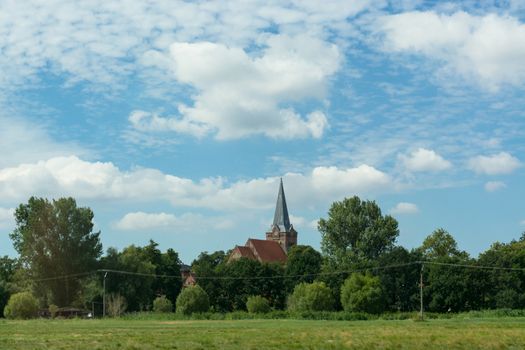 Countryside panorama blue sky Village church in the background