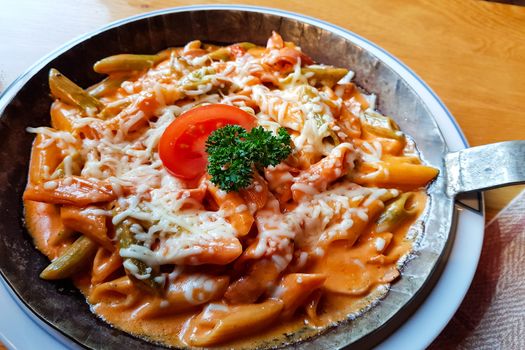 Pasta dish with fresh tomato sauce, mozzarella and basil