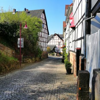 Beautiful view of historic traditional houses in old town in Europe with blue sky and clouds in summer. Kaufungen, Germany.