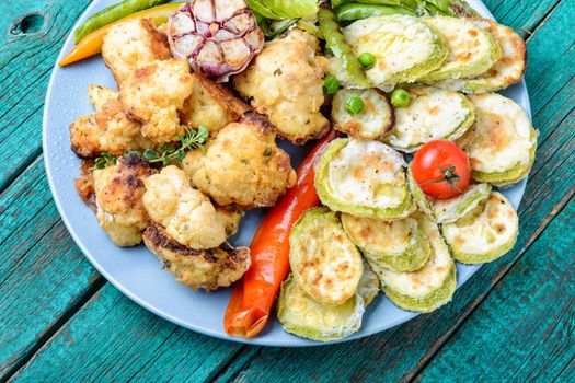 Grilled peas,cauliflower and zucchini.Grill vegetables.Summer food.Baked vegetables.Vegetarian food