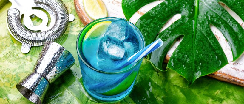 Blue alcoholic cocktail with ice and lime.Blue lagoon cocktail