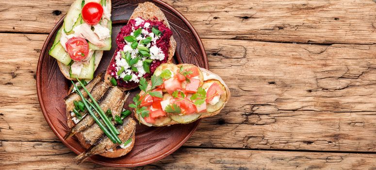 Assortment of italian traditional bruschetta.Appetizing bruschetta.Variety of small sandwiches