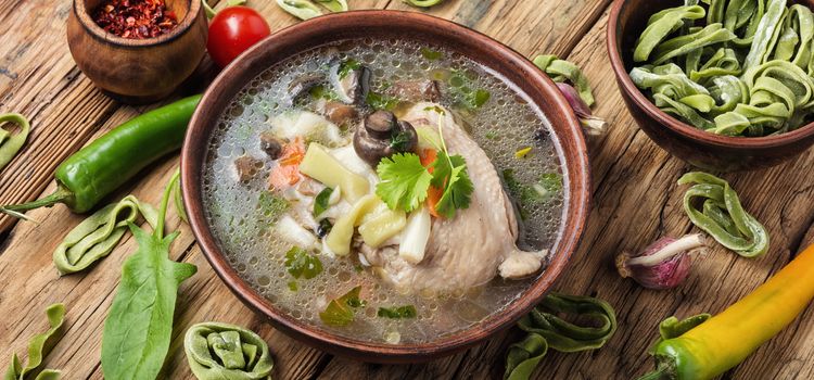 Chicken noodle soup on wooden table.Chicken soup with noodles