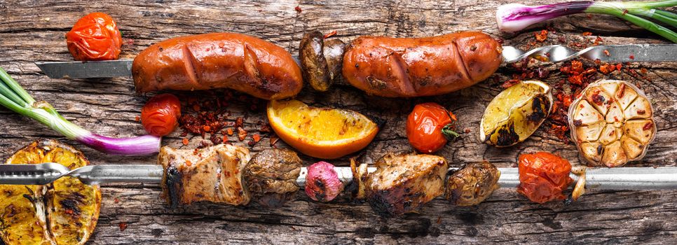 Assortment of grilled dishes, kebabs, sausages and grilled vegetables