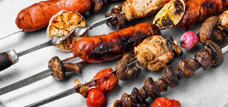 Assortment of grilled dishes, kebabs, sausages and grilled vegetables