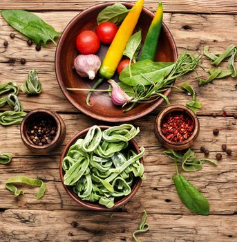 Spinach Noodles.Handmade noodles and ingredients on wood background