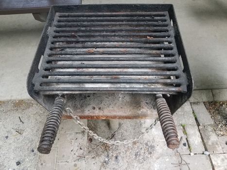 dirty or filthy barbecue grill metal bars with charcoal ash