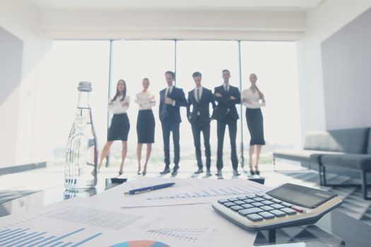 Close up view of printed graphs and business people discussing financial data