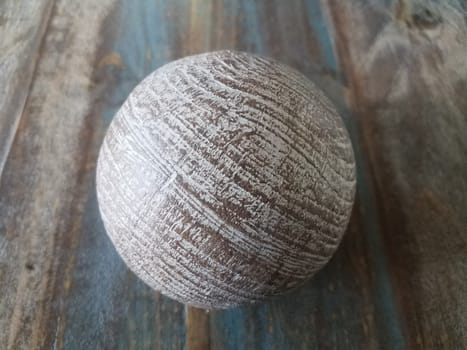 brown metal ball or sphere on brown wooden table
