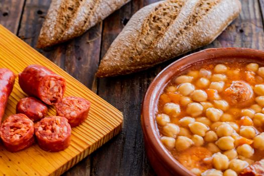 Chickpea dish and ingredients in composition on wooden background