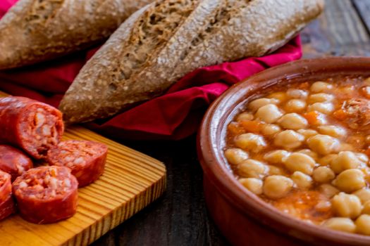 Chickpea dish and ingredients in composition on wooden background
