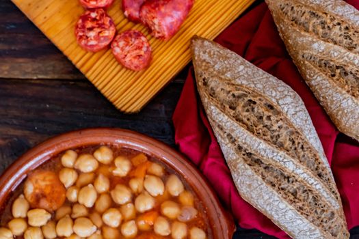 Chickpea dish and ingredients in composition on wooden background
