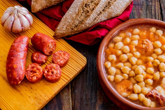 Chickpea dish and ingredients in composition on wooden background