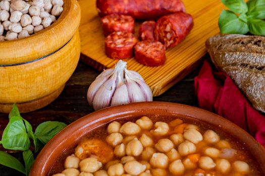 Chickpea dish and ingredients in composition on wooden background