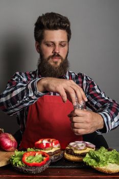 Man cooking fresh self made burger close up