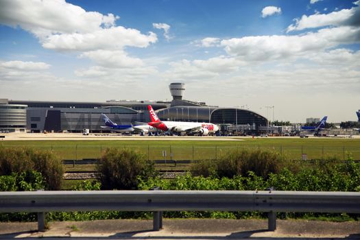 Miami, Florida, USA - May 9, 2013: Panoramic photo of the famous Miami International Airport with lots of airplanes loading and unloading passenger and cargo on May 9, 2013 in Miami, Florida, USA.