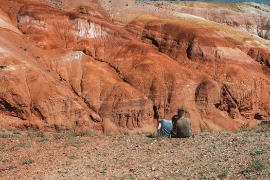 Relaxing man and woman in Valley of Mars landscapes in the Altai Mountains, Kyzyl Chin, Siberia, Russia