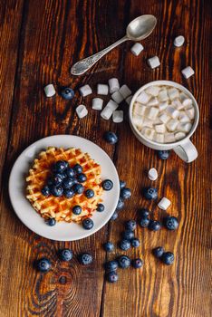Waffles with Fresh Blueberry and Honey on Plate, Cup of Coffee with Marshmallow.Vertical Orientation.